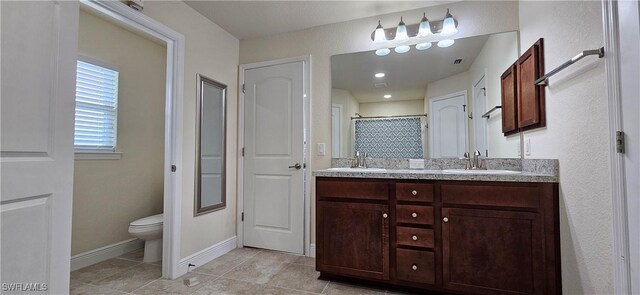 1948 Redmont Ave, Lehigh Acres, FL 33972 - full bathroom with toilet, tile patterned flooring, double vanity, baseboards, and curtained shower