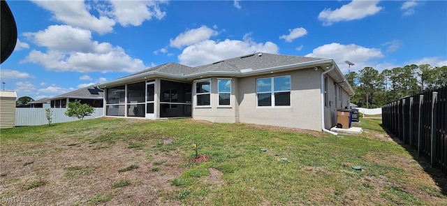 1948 Redmont Ave, Lehigh Acres, FL 33972 - back of property featuring a sunroom, a fenced backyard, and stucco siding
