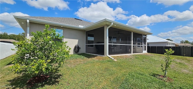 1948 Redmont Ave, Lehigh Acres, FL 33972 - back of property with a sunroom, ceiling fan, and stucco siding