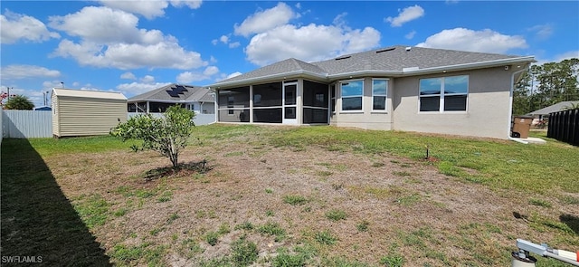 1948 Redmont Ave, Lehigh Acres, FL 33972 - back of property featuring a sunroom, stucco siding, and a storage shed