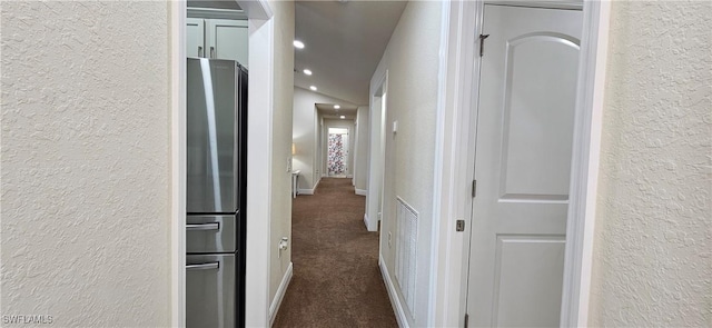 1948 Redmont Ave, Lehigh Acres, FL 33972 - corridor featuring a textured wall, dark carpet, and recessed lighting
