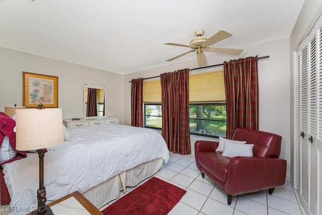 tiled bedroom featuring a closet and a ceiling fan