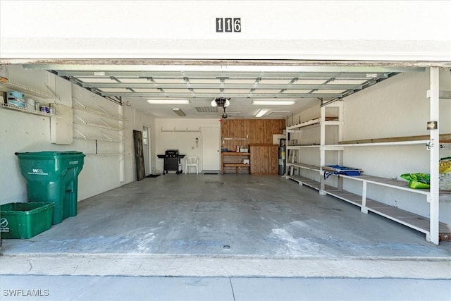 garage featuring water heater and a garage door opener