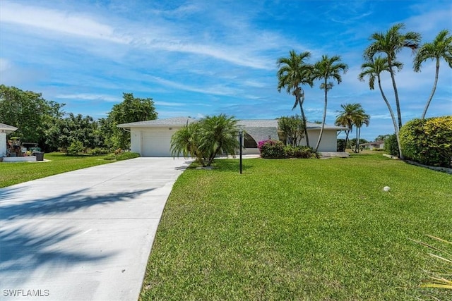view of front of home featuring concrete driveway, a front yard, and a garage