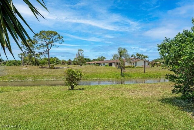 116 Short Ct, Naples, FL 34112 - view of green lawn featuring a water view