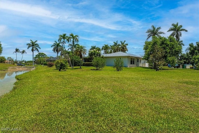view of grassy yard with a water view