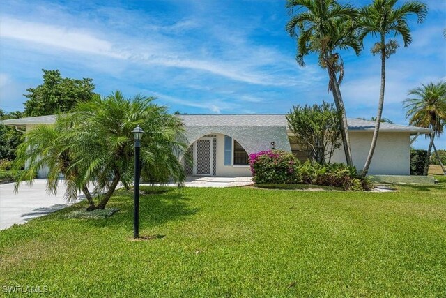 116 Short Ct, Naples, FL 34112 - view of front of house with a front yard, stucco siding, and concrete driveway