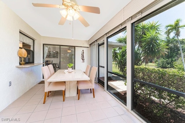 sunroom / solarium featuring ceiling fan and outdoor dining area