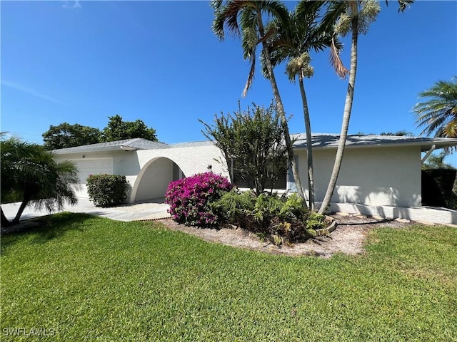116 Short Ct, Naples, FL 34112 - view of property exterior featuring stucco siding, a lawn, and an attached garage