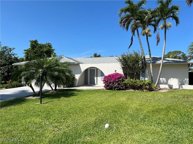 116 Short Ct, Naples, FL 34112 - view of front of property with stucco siding and a front lawn