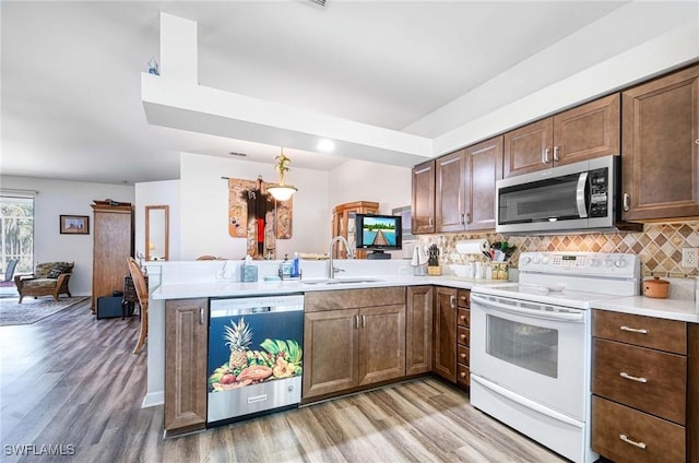 816 Mount Hood Ct, Naples, FL 34104 - kitchen featuring dishwashing machine, electric stove, stainless steel microwave, a sink, and a peninsula