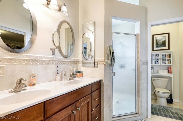 816 Mount Hood Ct, Naples, FL 34104 - full bathroom featuring a shower stall, tile walls, toilet, double vanity, and a wainscoted wall
