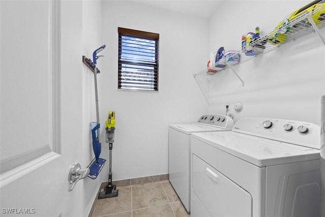 5692 Cassidy Ln, Ave Maria, FL 34142 - clothes washing area with washing machine and dryer, light tile patterned flooring, and baseboards