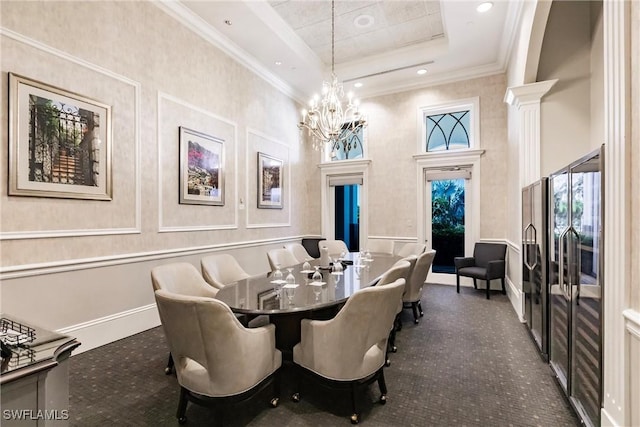 dining area with a raised ceiling, a towering ceiling, a chandelier, carpet, and ornamental molding