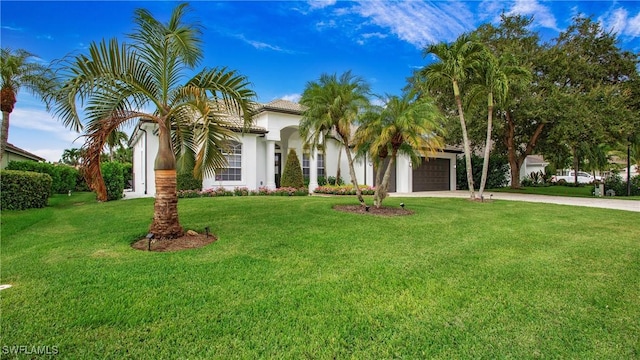 3936 Deep Passage Way, Naples, FL 34109 - mediterranean / spanish house with a garage, concrete driveway, a front yard, and stucco siding