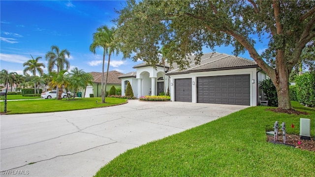 3936 Deep Passage Way, Naples, FL 34109 - mediterranean / spanish-style home featuring concrete driveway, a garage, a front lawn, stucco siding, and a tiled roof