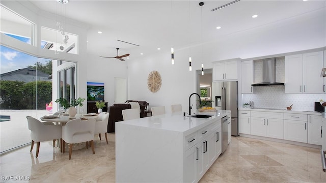 3936 Deep Passage Way, Naples, FL 34109 - kitchen with wall chimney exhaust hood, a sink, appliances with stainless steel finishes, backsplash, and a high ceiling