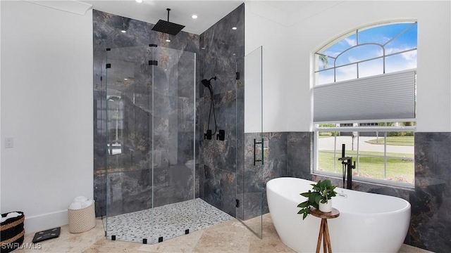 3936 Deep Passage Way, Naples, FL 34109 - full bath featuring a stall shower, a freestanding bath, and tile walls