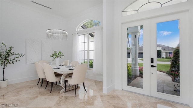 3936 Deep Passage Way, Naples, FL 34109 - dining space with healthy amount of natural light, baseboards, a towering ceiling, and french doors