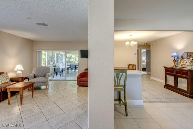 7232 Saint Anns Ct, Fort Myers, FL 33908 - living room with light tile patterned flooring, a chandelier, and a textured ceiling