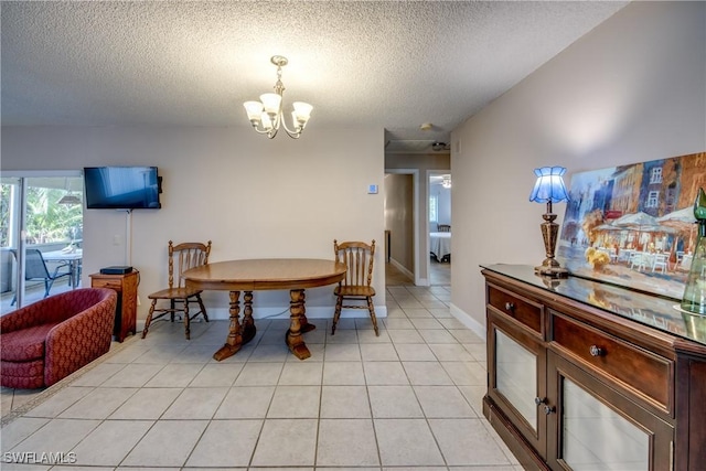7232 Saint Anns Ct, Fort Myers, FL 33908 - dining area with a textured ceiling, a chandelier, and light tile patterned flooring