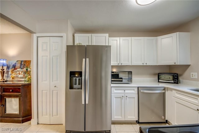 7232 Saint Anns Ct, Fort Myers, FL 33908 - kitchen featuring appliances with stainless steel finishes, white cabinets, and light tile patterned floors