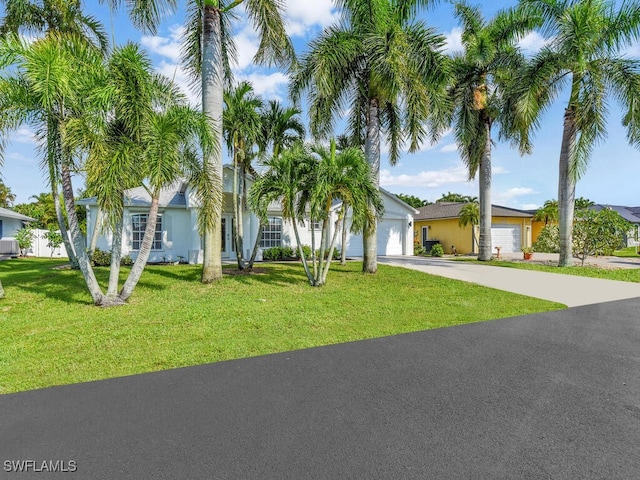 3521 SE Santa Barbara Pl, Cape Coral, FL 33914 - view of front facade with concrete driveway, a front lawn, and an attached garage