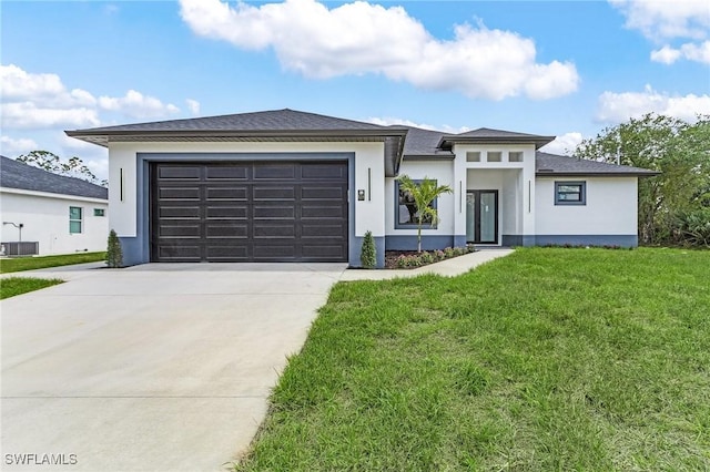 634 Raintree St E, Lehigh Acres, FL 33974 - prairie-style house featuring stucco siding, concrete driveway, and a garage