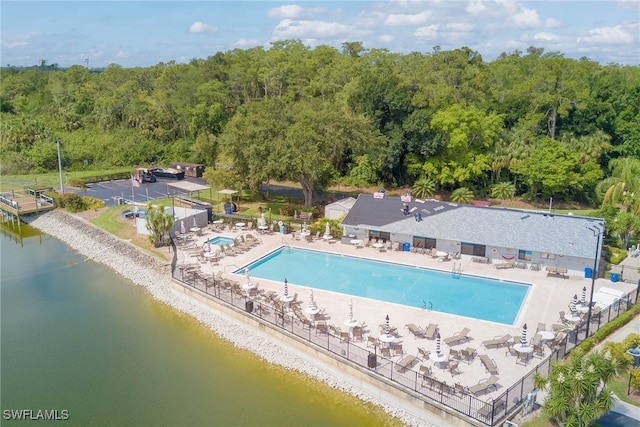 9950 Sailview Ct Unit 14, Fort Myers, FL 33905 - community pool featuring a patio, a water view, and a view of trees