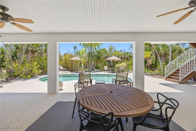 3008 Turtle Gait Ln, Sanibel, FL 33957 - view of patio featuring ceiling fan, stairs, outdoor dining area, and an outdoor pool
