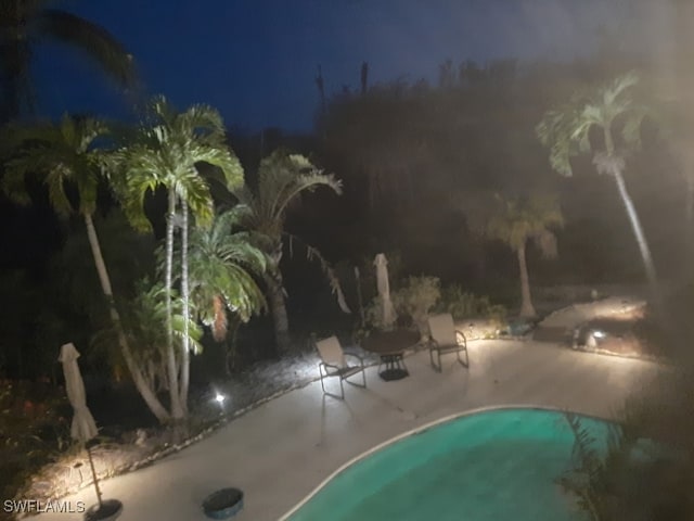 3008 Turtle Gait Ln, Sanibel, FL 33957 - pool at twilight with a patio area and an outdoor pool