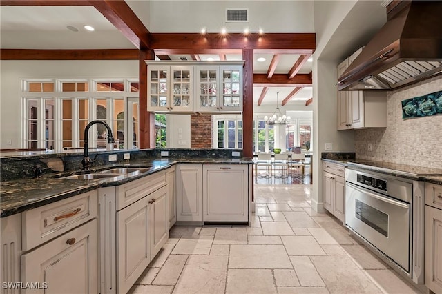 1419 Hemingway Pl, Naples, FL 34103 - kitchen featuring oven, custom range hood, a sink, beam ceiling, and stone tile floors