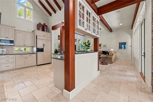 1419 Hemingway Pl, Naples, FL 34103 - kitchen featuring paneled built in refrigerator, stainless steel microwave, stone tile flooring, beam ceiling, and glass insert cabinets