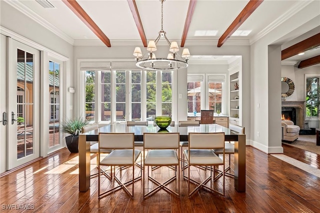 1419 Hemingway Pl, Naples, FL 34103 - dining area featuring dark wood-style floors, beam ceiling, a chandelier, a warm lit fireplace, and plenty of natural light