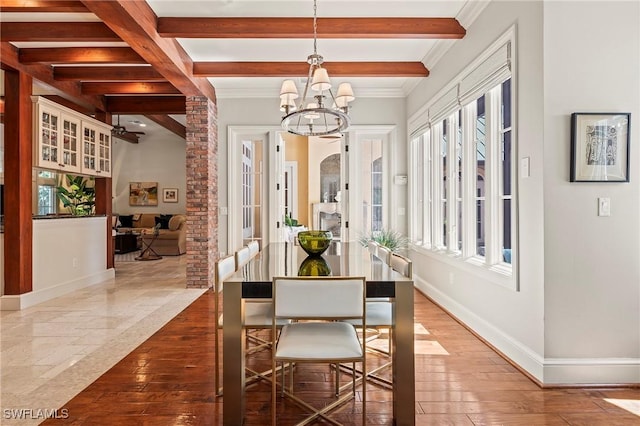 1419 Hemingway Pl, Naples, FL 34103 - dining area featuring a chandelier, beam ceiling, baseboards, ornamental molding, and hardwood / wood-style floors