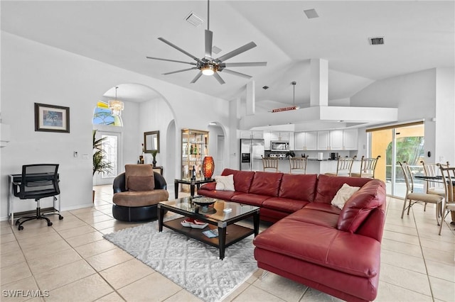 2005 SE 21st St, Cape Coral, FL 33990 - living area featuring arched walkways, light tile patterned flooring, a ceiling fan, and high vaulted ceiling