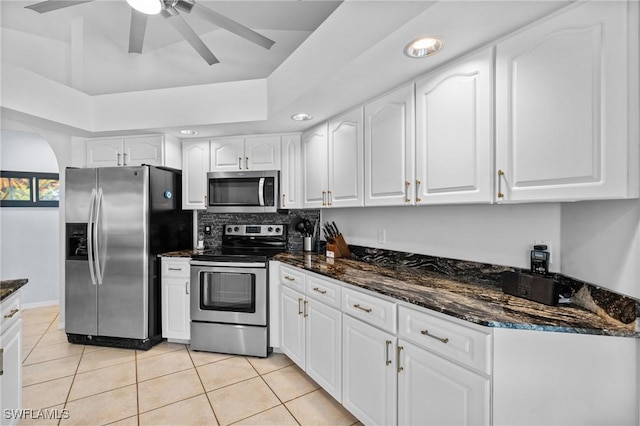 2005 SE 21st St, Cape Coral, FL 33990 - kitchen featuring appliances with stainless steel finishes, dark stone counters, white cabinetry, light tile patterned flooring, and recessed lighting