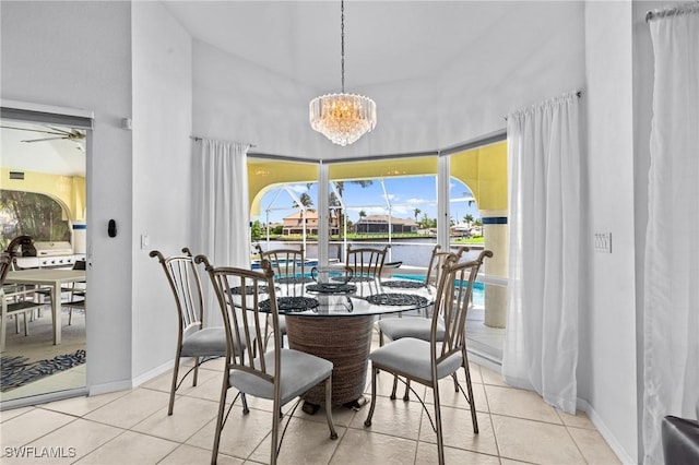 2005 SE 21st St, Cape Coral, FL 33990 - dining space with light tile patterned flooring, a chandelier, a towering ceiling, and baseboards