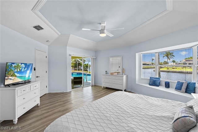 2005 SE 21st St, Cape Coral, FL 33990 - bedroom with access to exterior, wood finished floors, a water view, a ceiling fan, and baseboards