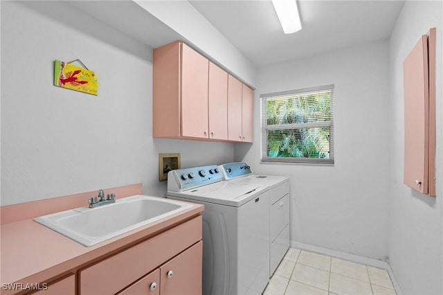 2005 SE 21st St, Cape Coral, FL 33990 - clothes washing area with washing machine and dryer, cabinet space, light tile patterned flooring, and baseboards