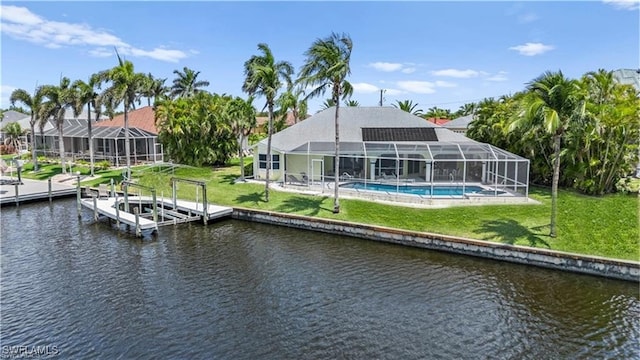 2005 SE 21st St, Cape Coral, FL 33990 - dock with a water view, a lawn, boat lift, a lanai, and an outdoor pool