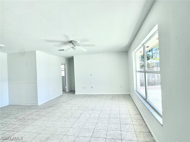 844 106th Ave N, Naples, FL 34108 - unfurnished room with a ceiling fan, light tile patterned floors, and baseboards