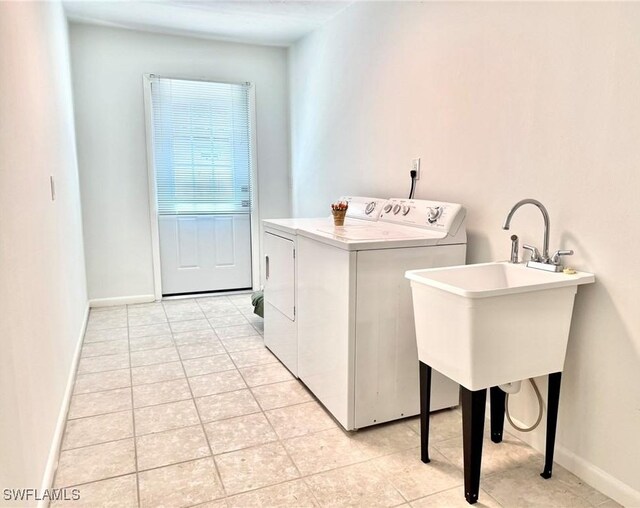 844 106th Ave N, Naples, FL 34108 - laundry area featuring washing machine and clothes dryer, light tile patterned floors, and baseboards