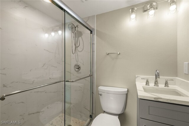 7400 Estero Blvd Unit 125, Fort Myers Beach, FL 33931 - bathroom featuring a marble finish shower, toilet, and vanity