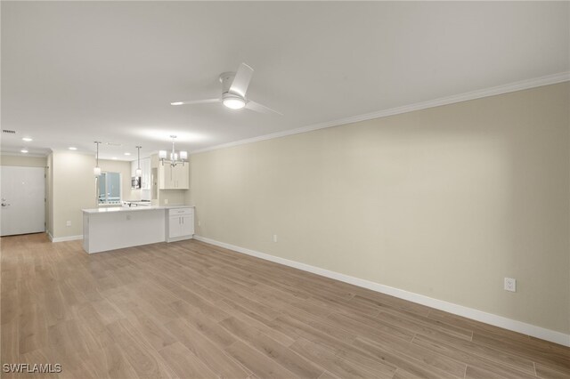7400 Estero Blvd Unit 125, Fort Myers Beach, FL 33931 - unfurnished living room featuring a chandelier, ornamental molding, light wood-style flooring, ceiling fan, and baseboards