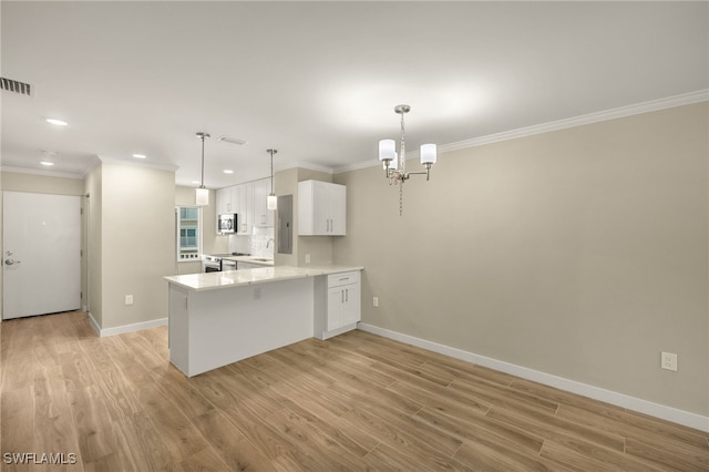 7400 Estero Blvd Unit 125, Fort Myers Beach, FL 33931 - kitchen with stainless steel appliances, crown molding, white cabinets, light wood finished floors, and baseboards