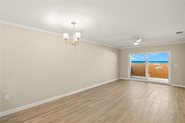 7400 Estero Blvd Unit 125, Fort Myers Beach, FL 33931 - unfurnished room with ornamental molding, light wood finished floors, baseboards, and a chandelier