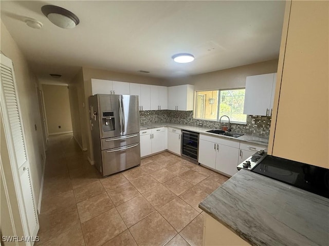 4335 18th Ave SE, Naples, FL 34117 - kitchen with stainless steel fridge with ice dispenser, wine cooler, a sink, tasteful backsplash, and white cabinets