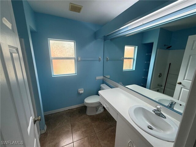 4335 18th Ave SE, Naples, FL 34117 - bathroom with toilet, healthy amount of natural light, vanity, and tile patterned floors