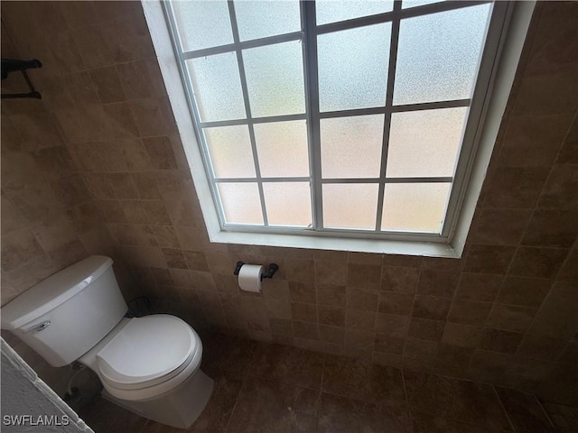 4335 18th Ave SE, Naples, FL 34117 - bathroom featuring tile walls, toilet, and tile patterned flooring